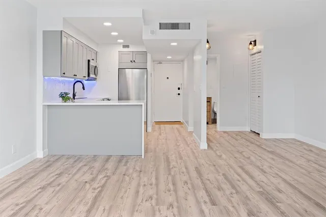a view of kitchen with wooden floor and window