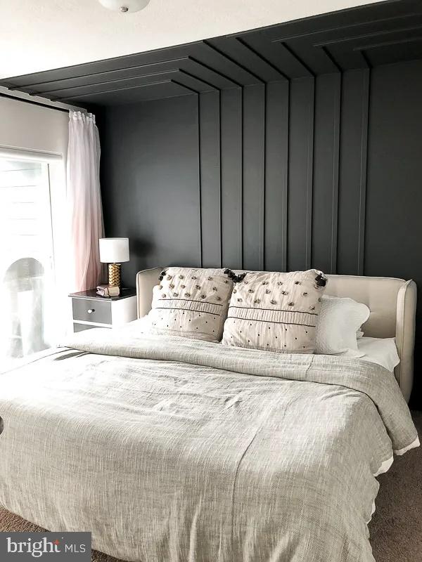 Any Fairfax, VA 22030 - Photo 13 of 19 a large bed sitting in a bedroom next to a cabinet and a window