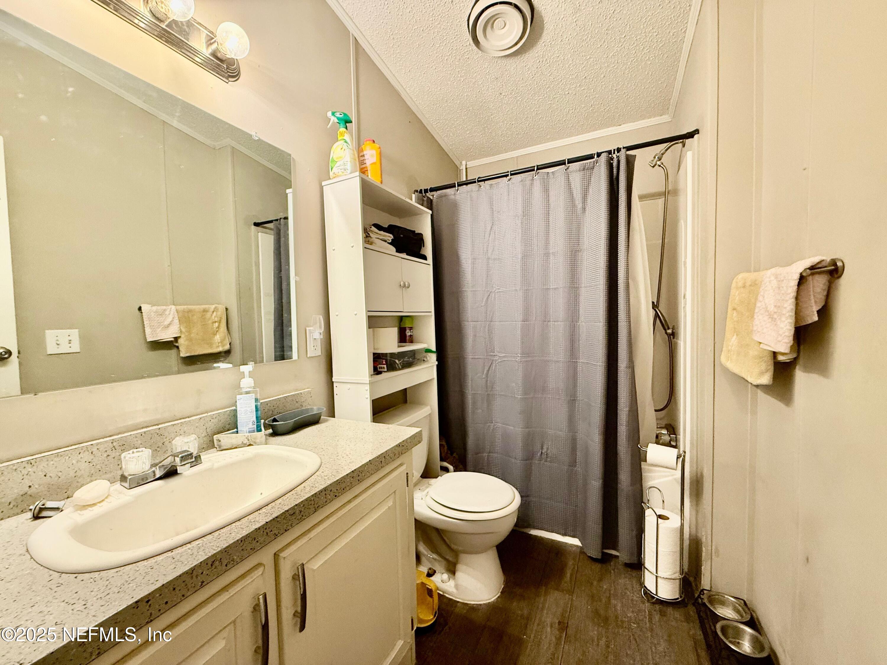 209 Dolphin Circle Middleburg, FL 32068 - Photo 15 of 20 a bathroom with a sink toilet and shower