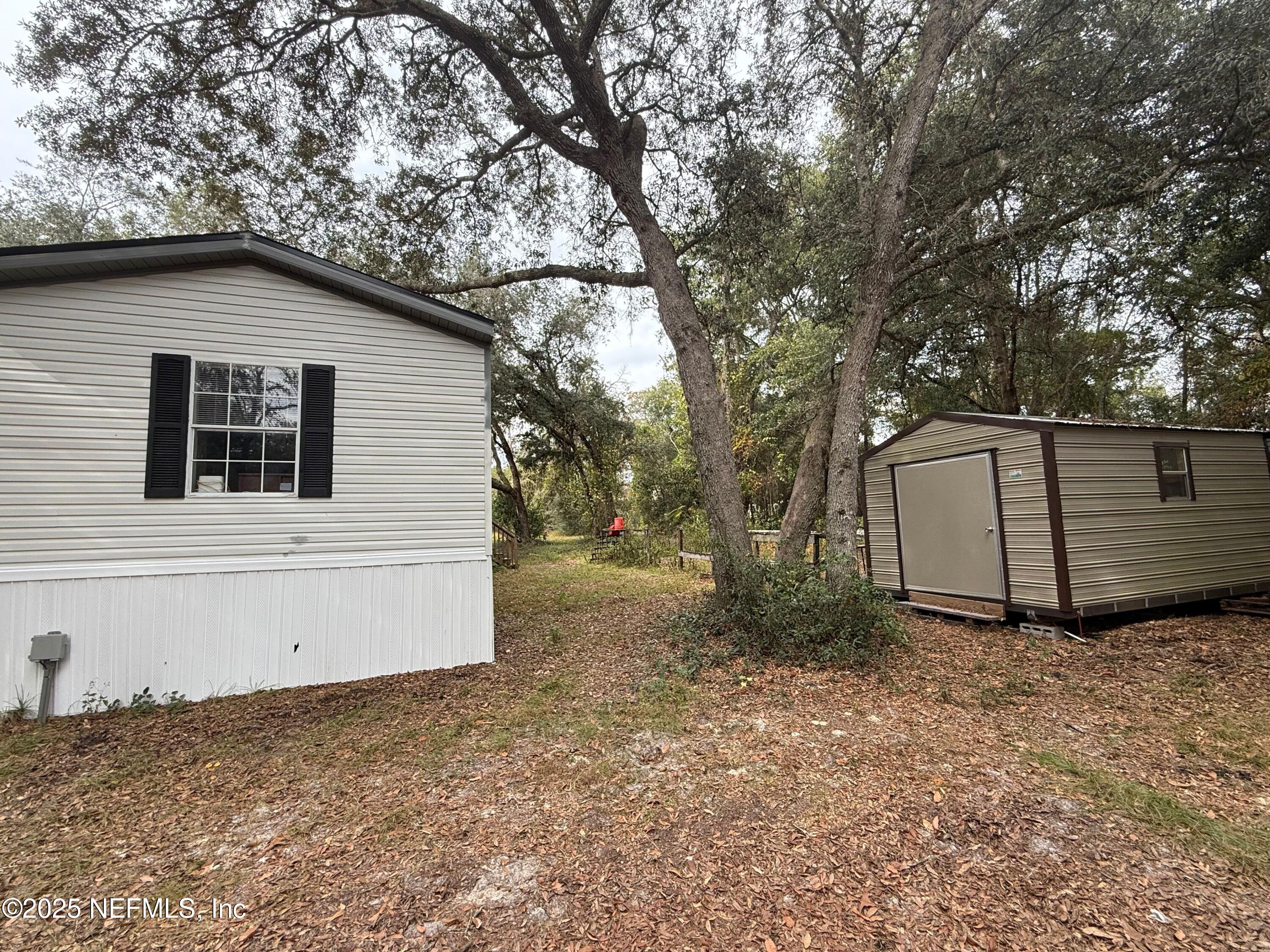 209 Dolphin Circle Middleburg, FL 32068 - Photo 18 of 20 a house with trees in the background