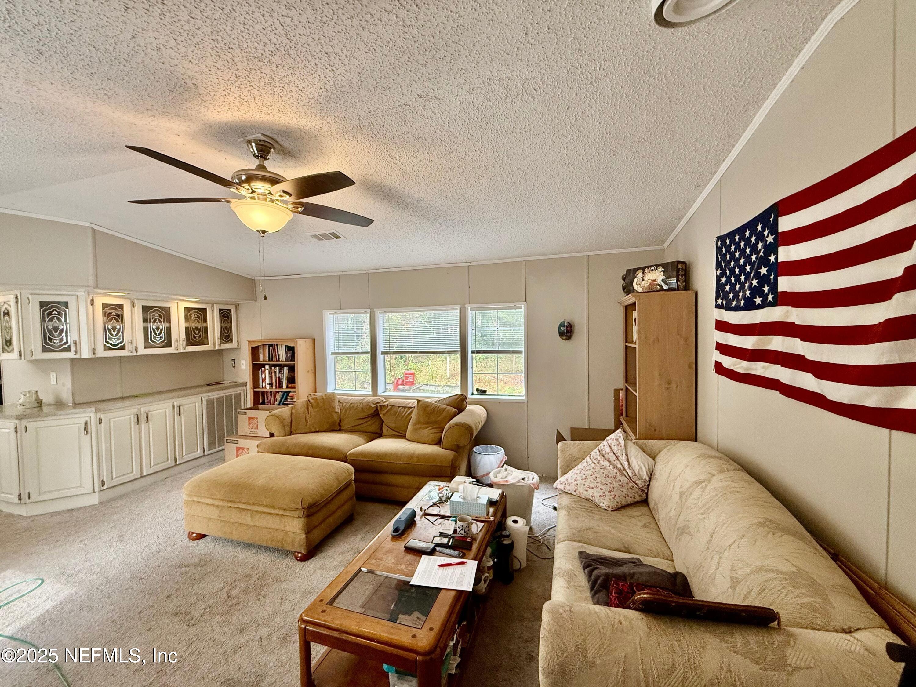 209 Dolphin Circle Middleburg, FL 32068 - Photo 2 of 20 a bedroom with furniture and a large window