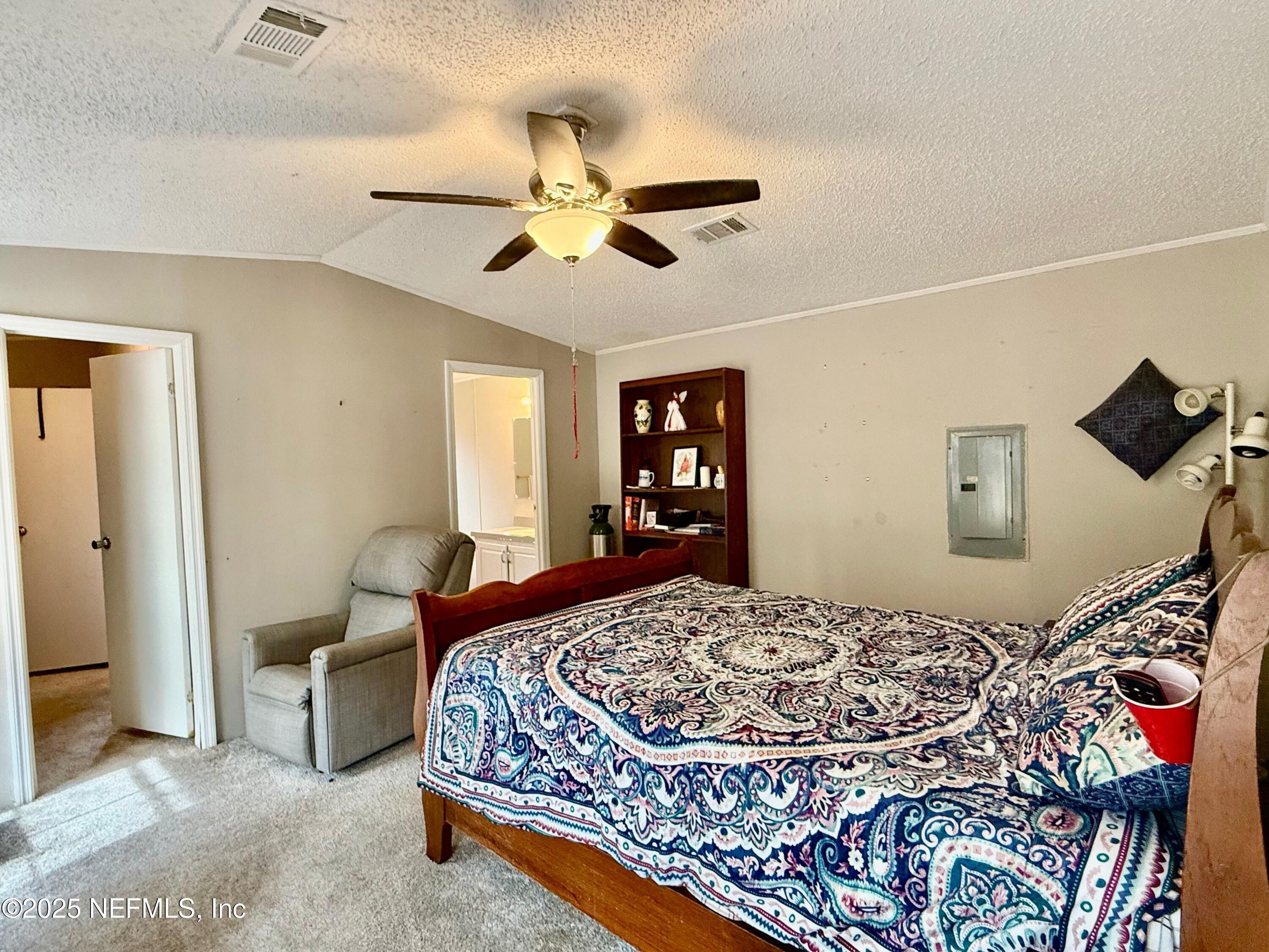 209 Dolphin Circle Middleburg, FL 32068 - Photo 9 of 20 a bedroom with a bed and ceiling fan