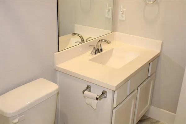a bathroom with a sink and a white vanity