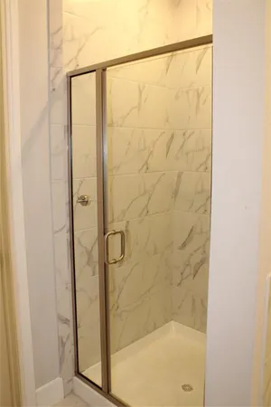 a bathroom with a glass shower door
