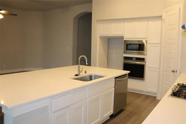 a kitchen with a sink and refrigerator