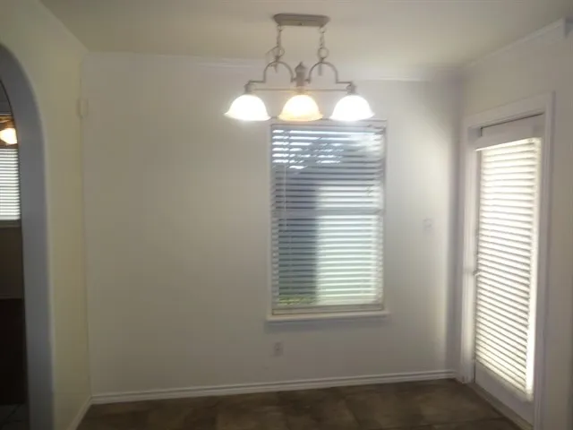 a view of a room with a windows and chandelier