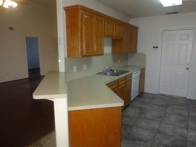 a kitchen with a sink a stove and cabinets