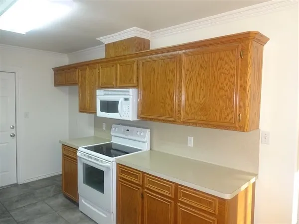 a kitchen with a sink cabinets and wooden floor