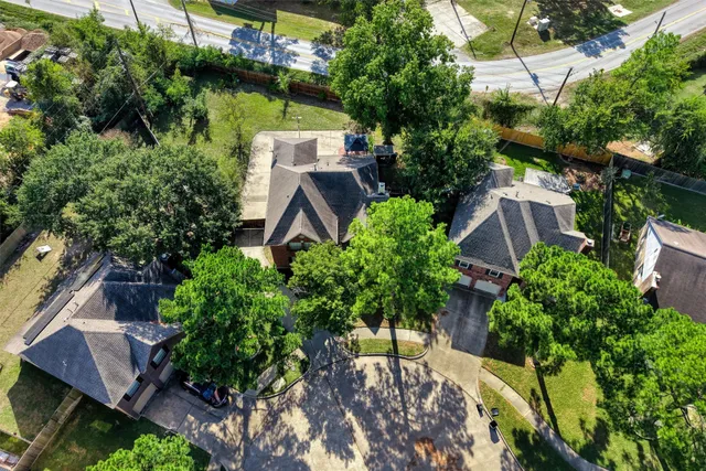 an aerial view of a house with swimming pool and garden