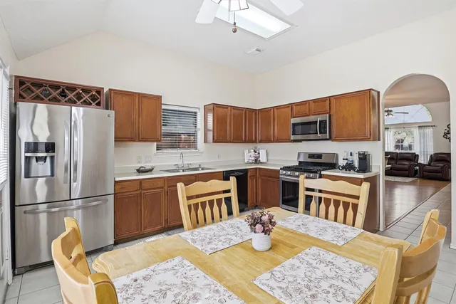 a view of a dining room with furniture and chandelier fan