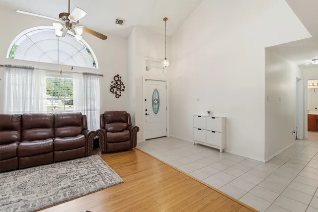 a living room with furniture a chandelier and a window