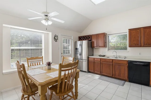 a kitchen with stainless steel appliances granite countertop a sink and cabinets