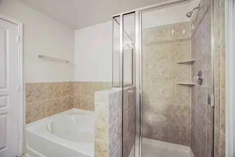 a bathroom with a bathtub and shower