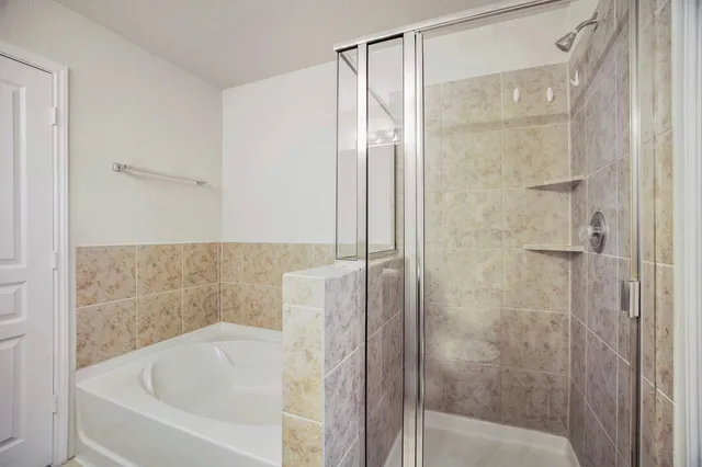 a bathroom with a bathtub and shower
