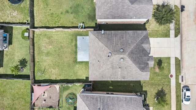 an aerial view of a house with a yard