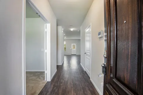 a view of hallway with wooden floor