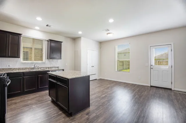 a kitchen with wooden floors and sink