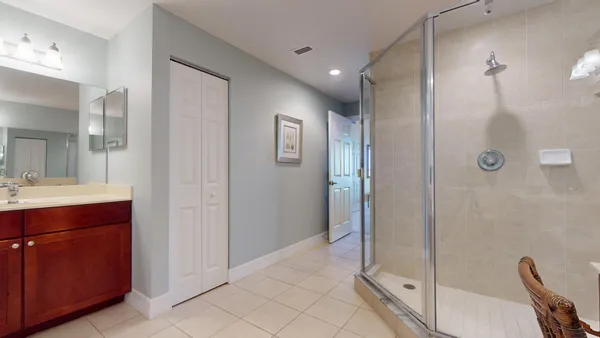 a bathroom with a toilet sink vanity tub and mirror
