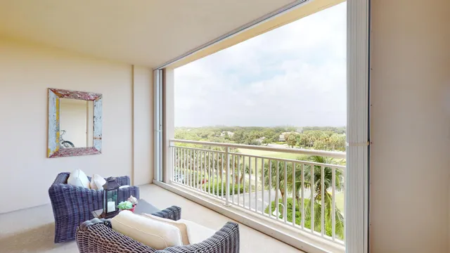 a view of a chairs and table in the balcony