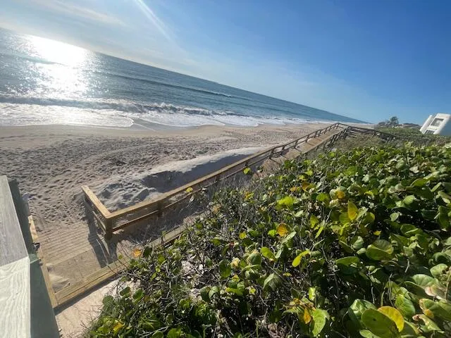 a view of a house with swimming pool and sitting area