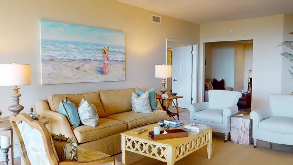 a living room with furniture and kitchen view