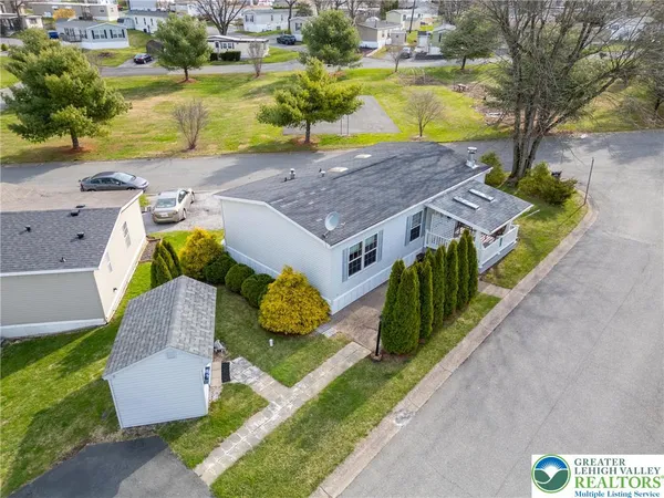 an aerial view of residential houses with outdoor space