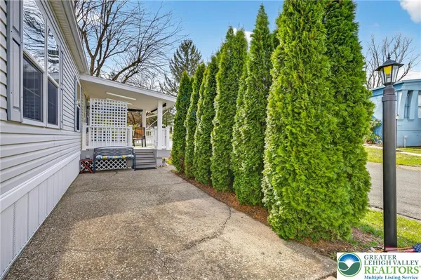 a view of a porch with furniture and a yard