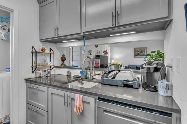 a kitchen with stainless steel appliances granite countertop a sink and cabinets