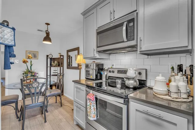 a kitchen with stainless steel appliances granite countertop a stove and a refrigerator