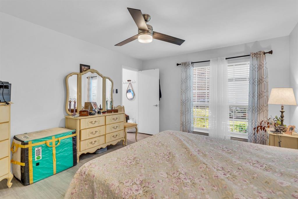 5981 Arapaho Road, Unit 1307 Dallas, TX 75248 - Photo 22 of 31 a bed room with a bed and a dresser