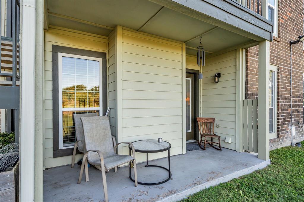 5981 Arapaho Road, Unit 1307 Dallas, TX 75248 - Photo 5 of 31 a view of a chair and table in backyard of the house