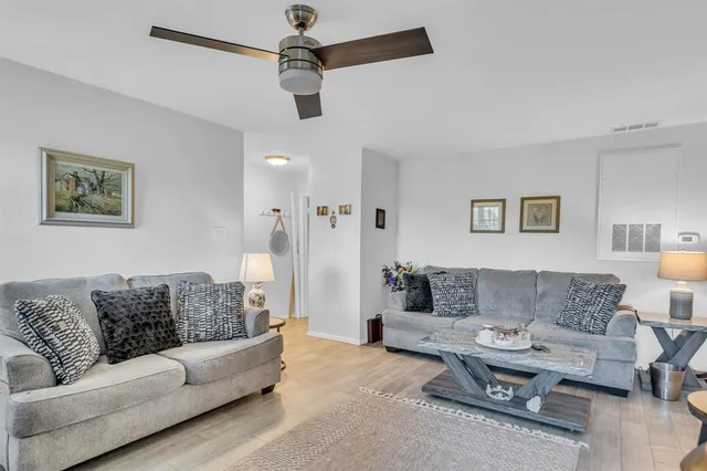 a living room with furniture and a lamp