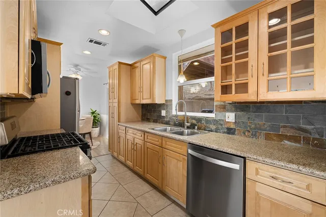 a kitchen with a sink stove and cabinets