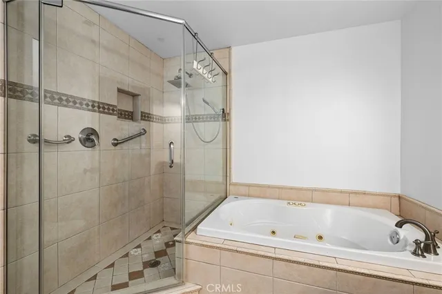 a bathroom with a tub and a shower