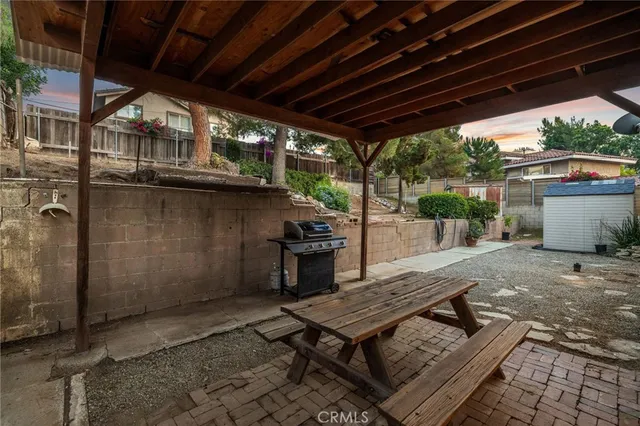 a view of a backyard with wooden floor and outdoor seating