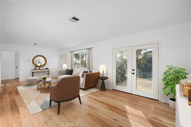 a living room with furniture a window and a table