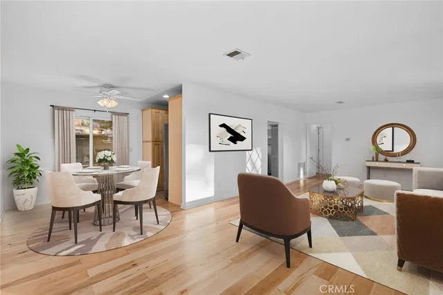 a living room with furniture a rug and a table