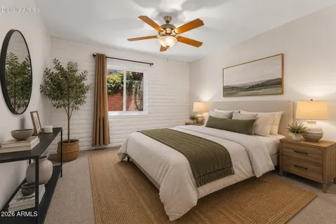 a bedroom with bed and a chandelier