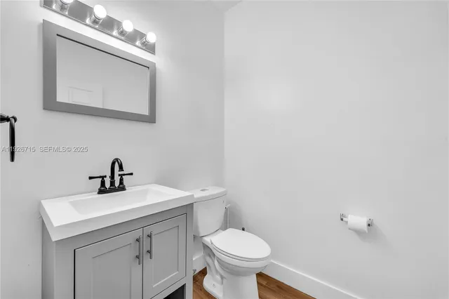 a bathroom with a double vanity sink a mirror and a bathtub