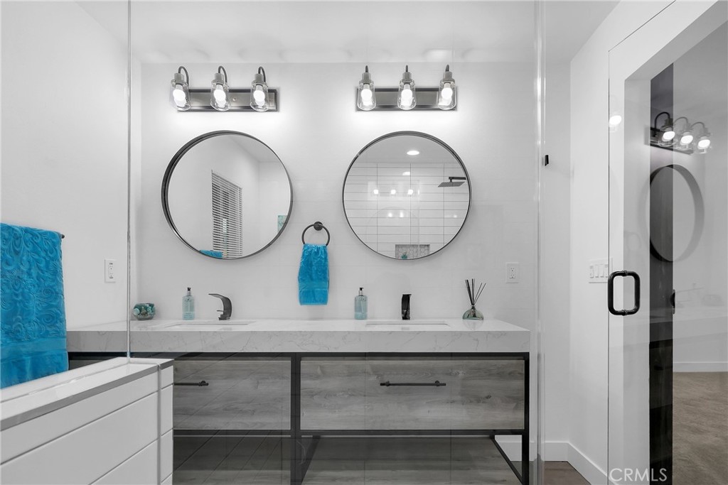 4312 Myra Avenue Cypress, CA 90630 - Photo 23 of 38 a bathroom with a two sink and a mirror