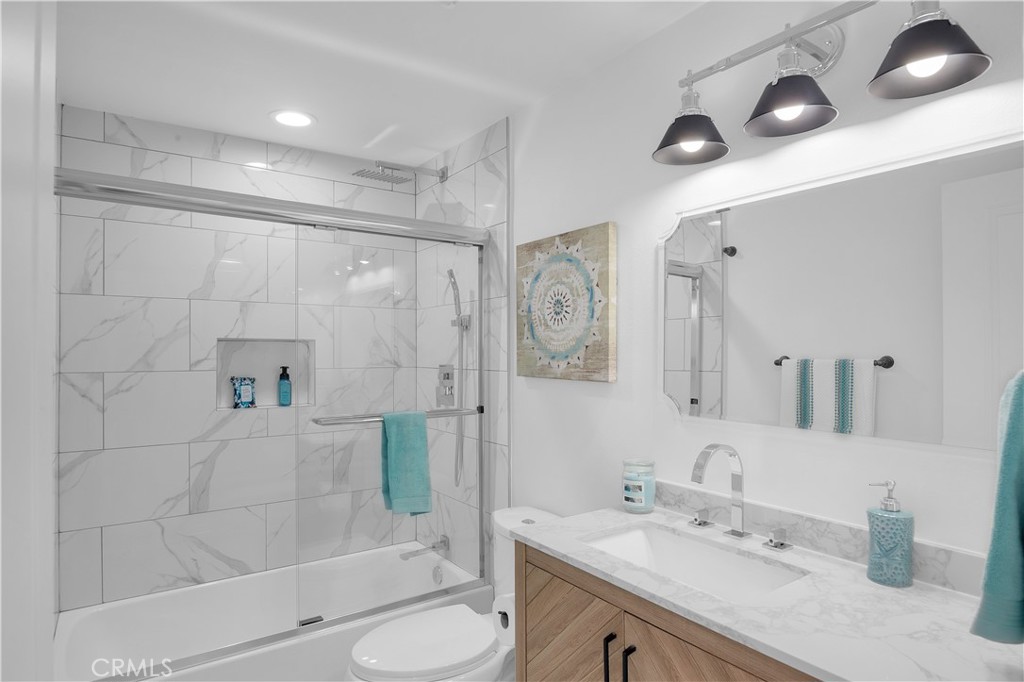 4312 Myra Avenue Cypress, CA 90630 - Photo 27 of 38 a bathroom with a sink a toilet and shower