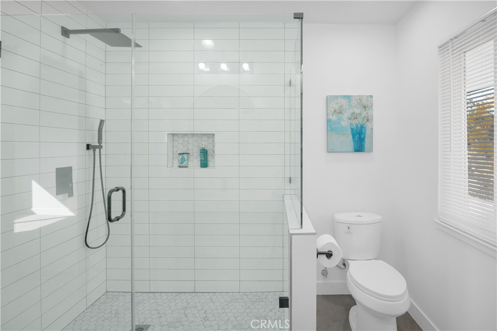 4312 Myra Avenue Cypress, CA 90630 - Photo 28 of 38 a bathroom with a toilet and a shower