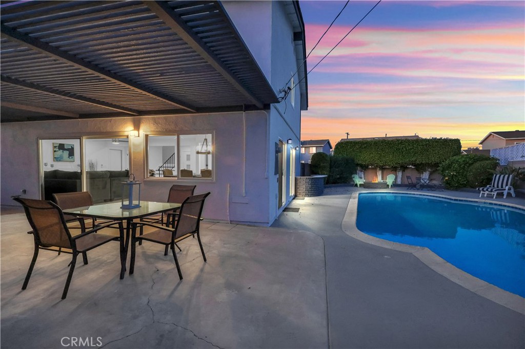 4312 Myra Avenue Cypress, CA 90630 - Photo 4 of 38 a view of a patio with dining table and chairs with wooden floor