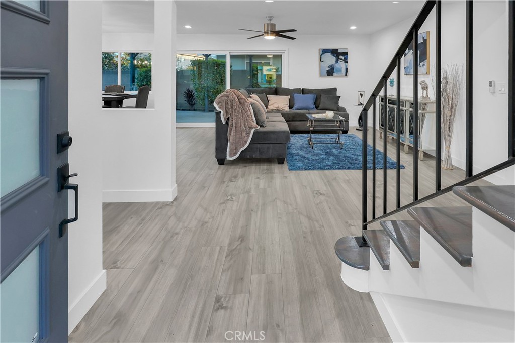 4312 Myra Avenue Cypress, CA 90630 - Photo 5 of 38 a living room with couches and a dining table with wooden floor