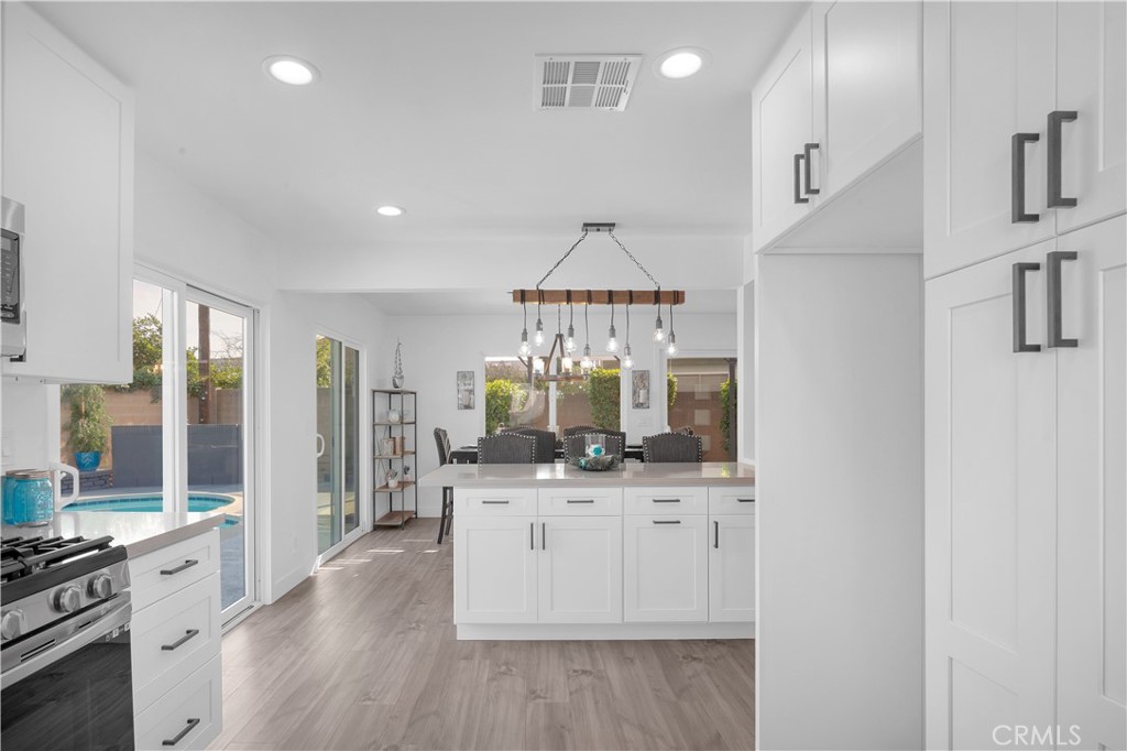 4312 Myra Avenue Cypress, CA 90630 - Photo 6 of 38 a kitchen with stainless steel appliances a stove sink and cabinets