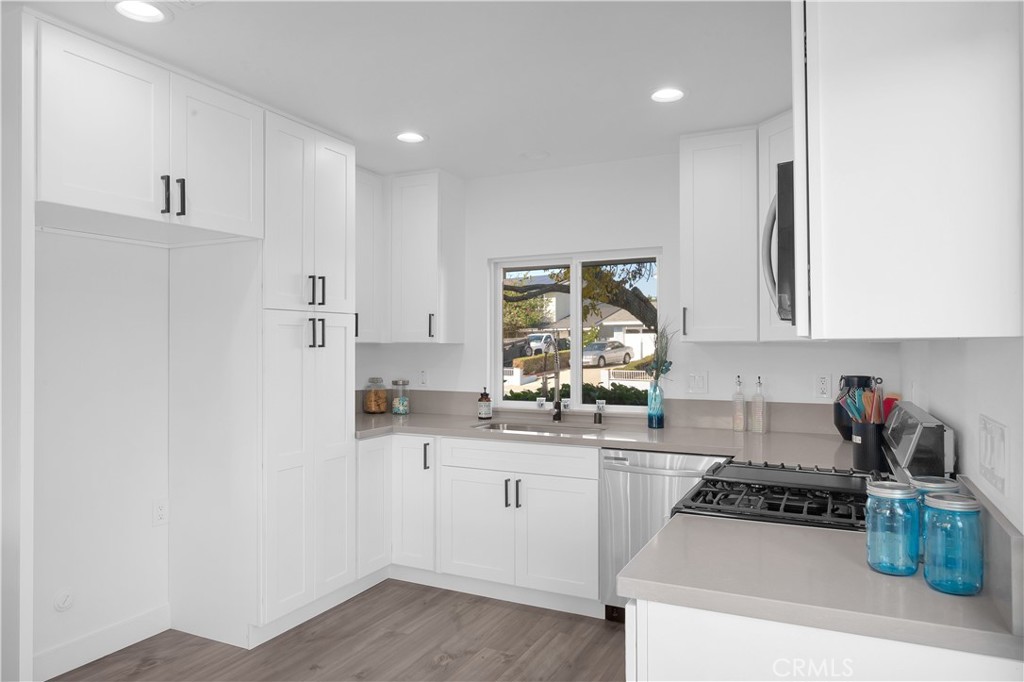 4312 Myra Avenue Cypress, CA 90630 - Photo 7 of 38 a kitchen with a sink a stove a refrigerator and cabinets