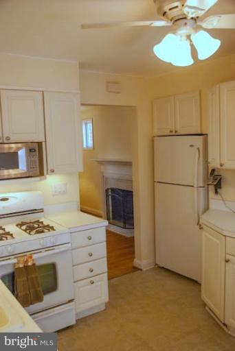 12607 Bluhill Road Silver Spring, MD 20906 - Photo 11 of 26 a kitchen with a stove and a refrigerator