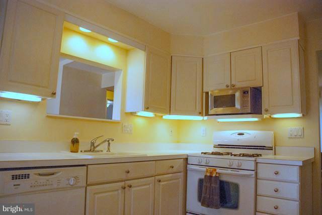 12607 Bluhill Road Silver Spring, MD 20906 - Photo 15 of 26 a kitchen with cabinets appliances and a counter top