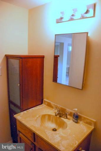 12607 Bluhill Road Silver Spring, MD 20906 - Photo 18 of 26 a bathroom with a sink and a mirror