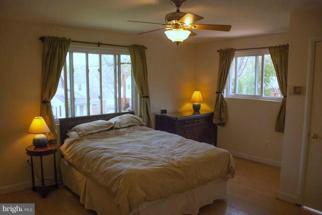 12607 Bluhill Road Silver Spring, MD 20906 - Photo 19 of 26 a bedroom with a bed and a chandelier